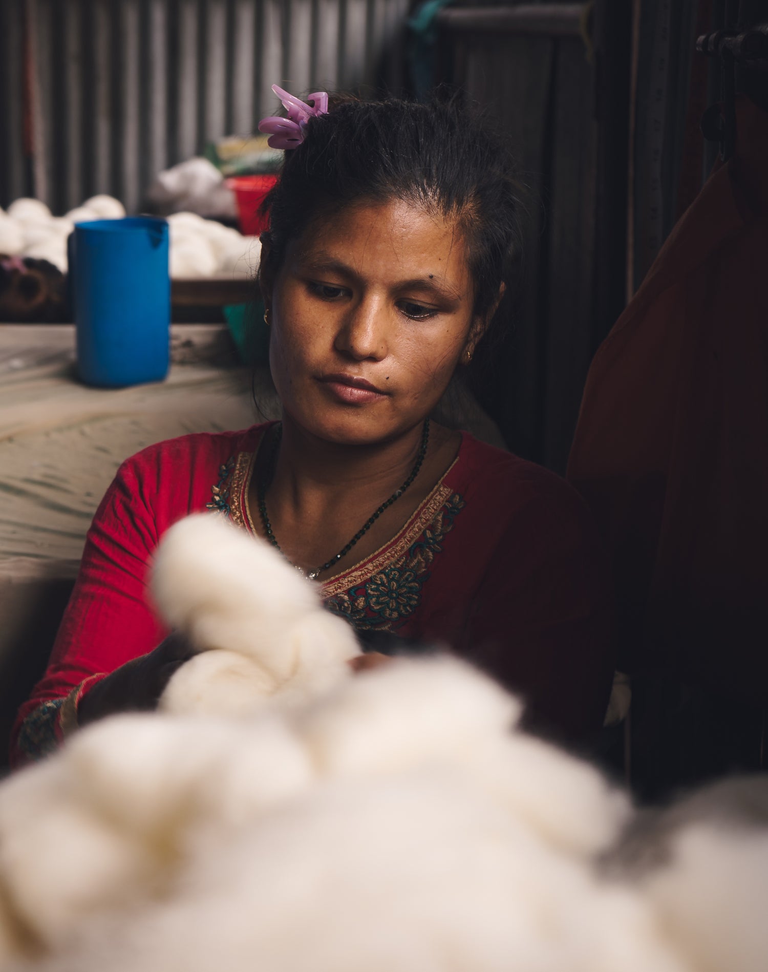Indian women cutting and measuring wool to make wool dryer balls. 