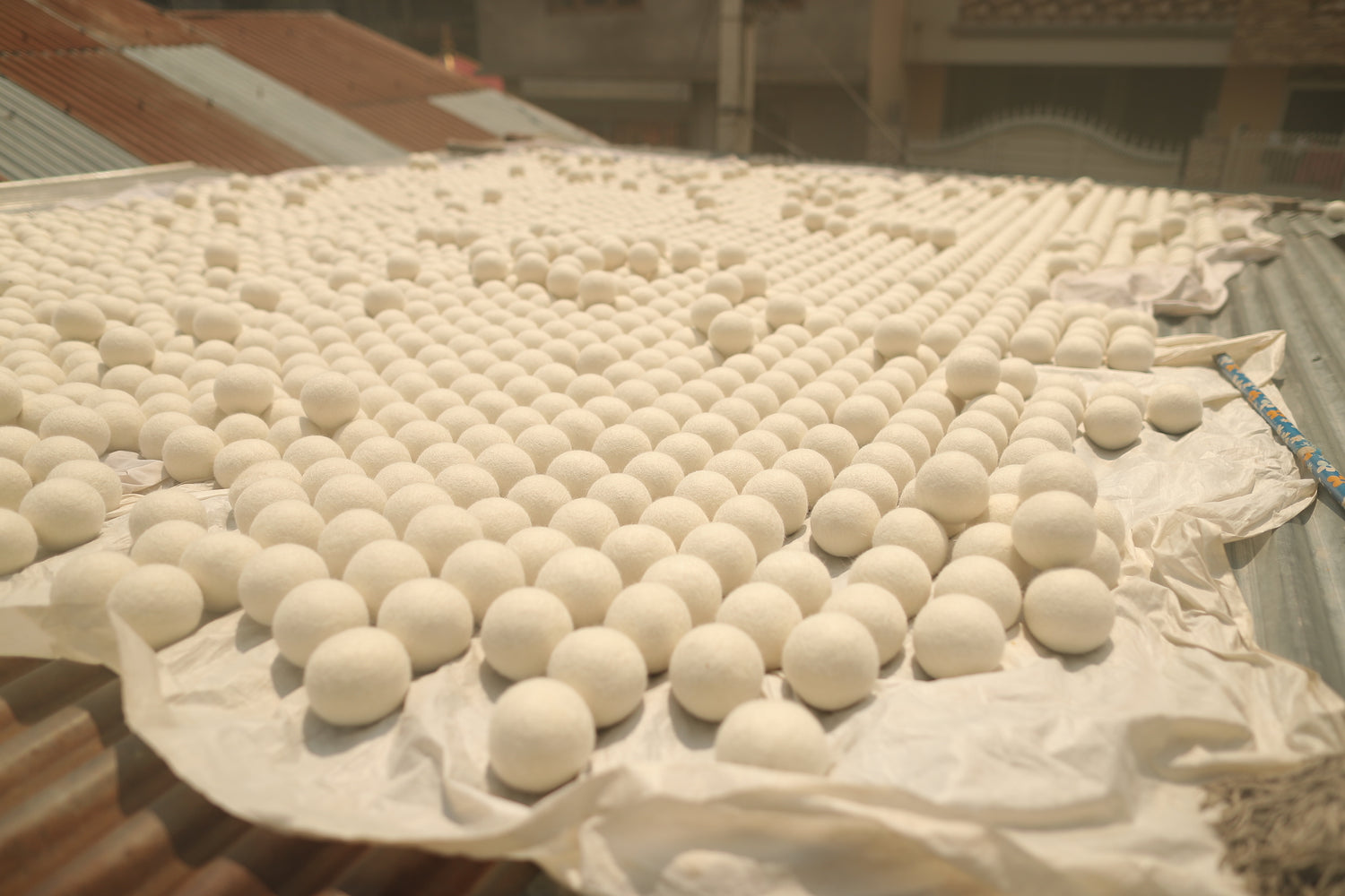 A large array of wool dryer balls ready to be packaged. 
