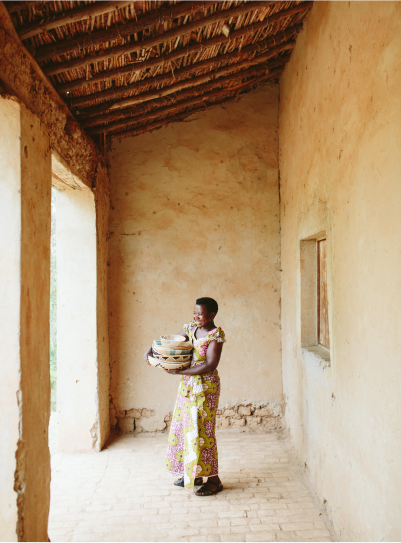 Artisan women from Rwanda standing with her works. 